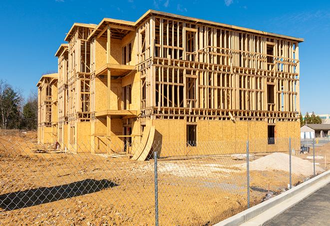 a temporary chain link fence locking away a building under renovation, serving as a security tool in Longmont